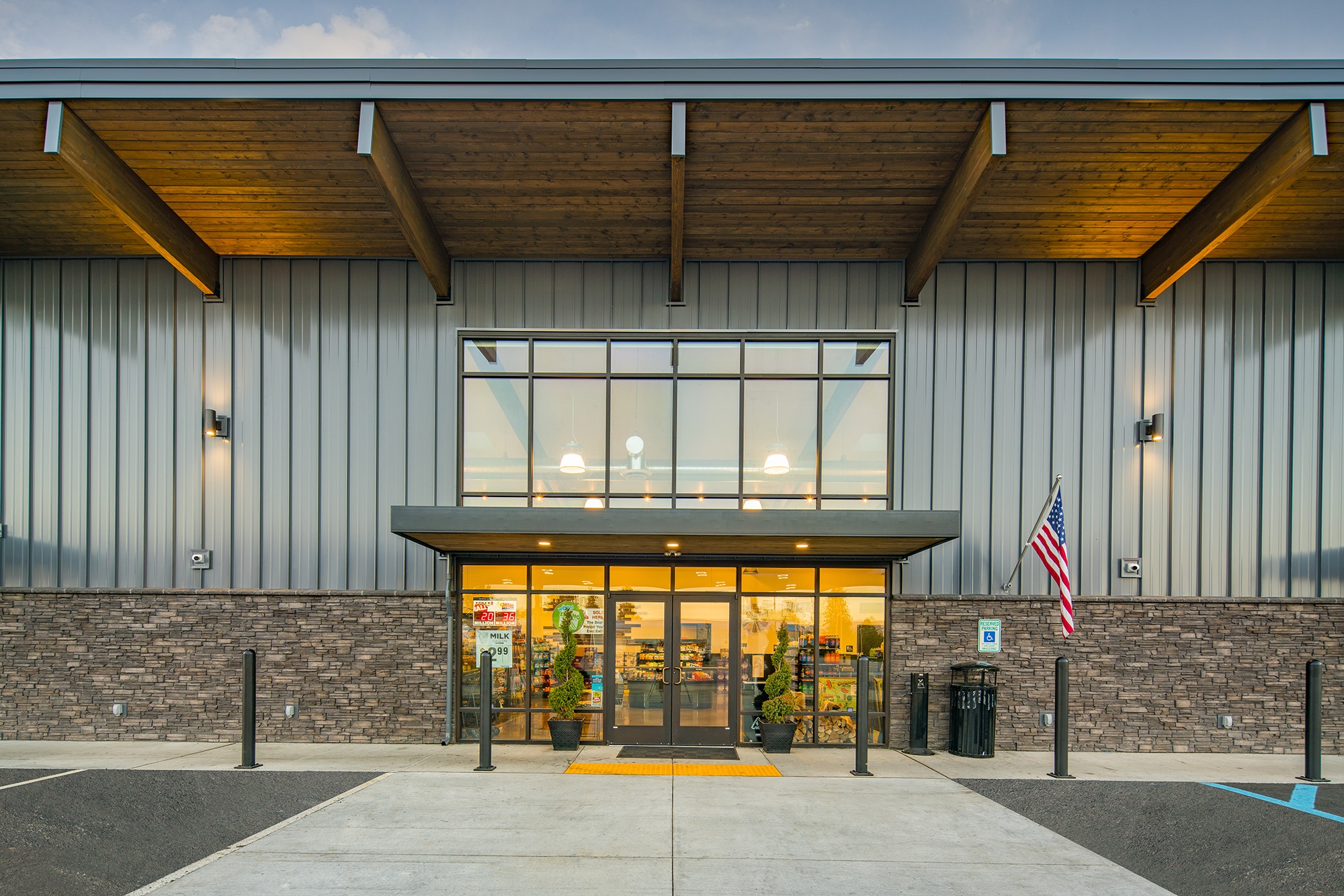 Front entry to Atlas Seltice Gas Station market in CDA with glass double doors and contemporary roof overhang