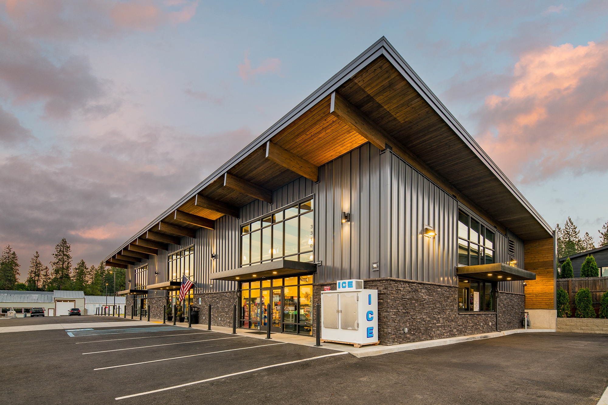Corner perspective of Atlas Seltice Gas Station with signage, stone accents, and entrance to the market/deli area