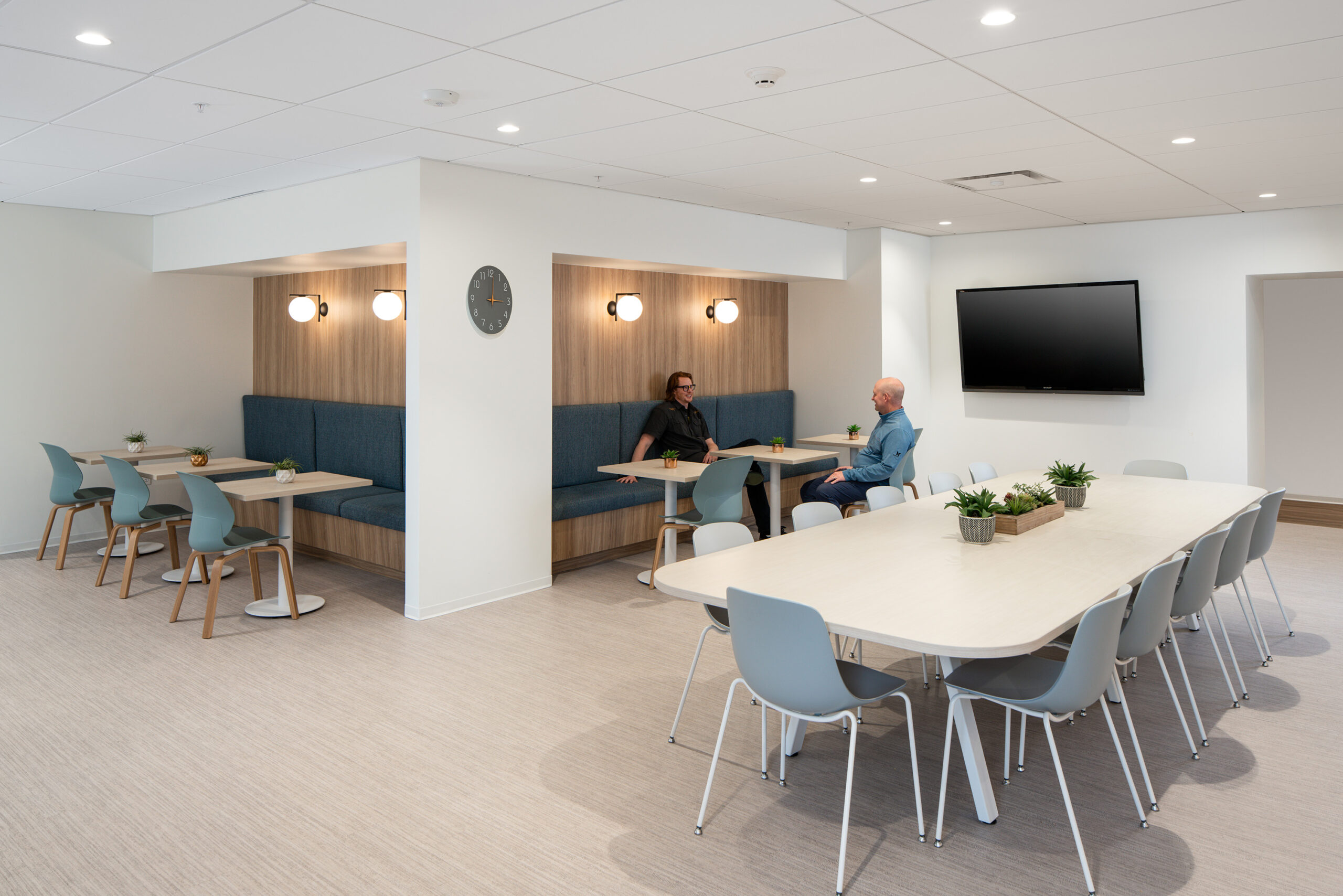 Employee breakroom at Coffman Engineering featuring kitchen amenities, seating area, and modern finishes by Fusion Architecture