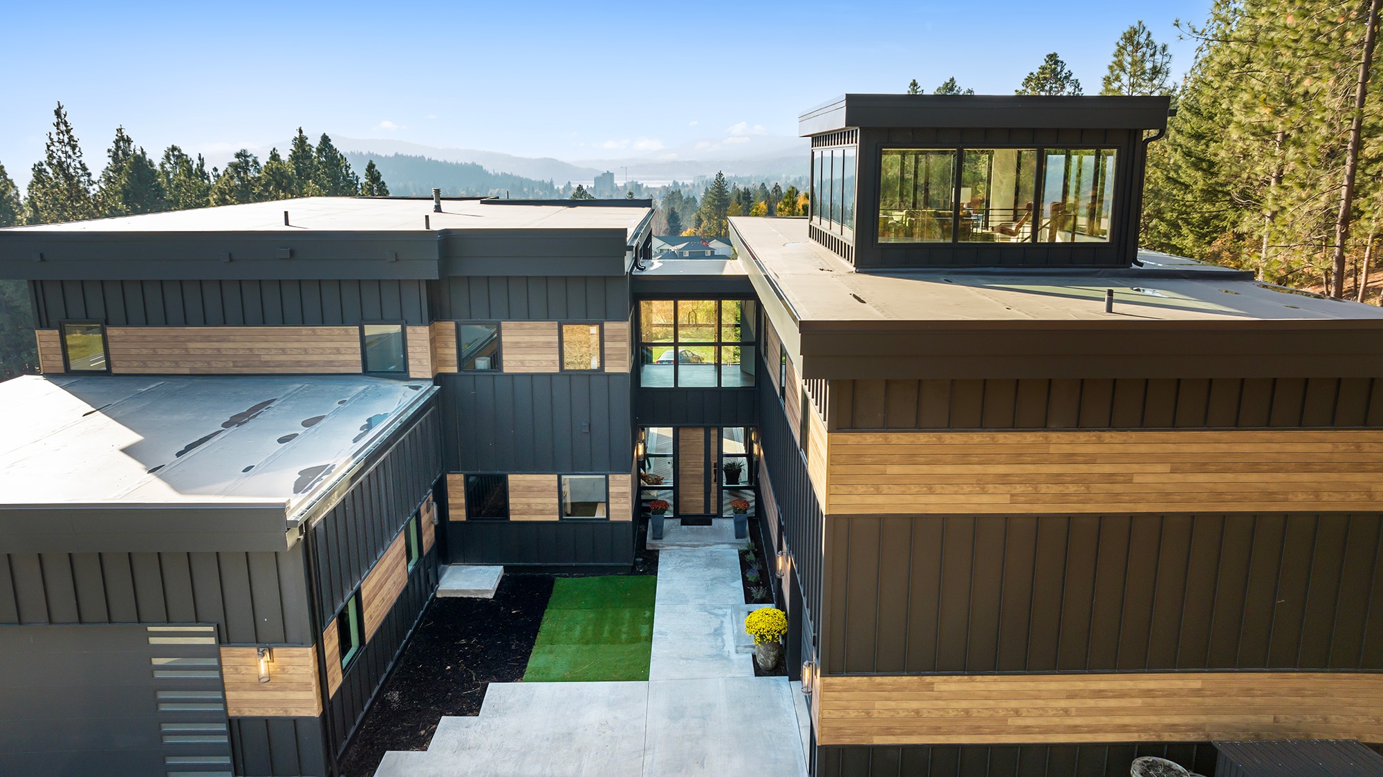 Fernan Hill Residence in CDA, Idaho — hillside home blending cedar siding, glass walls, and steel elements designed by Fusion Architecture