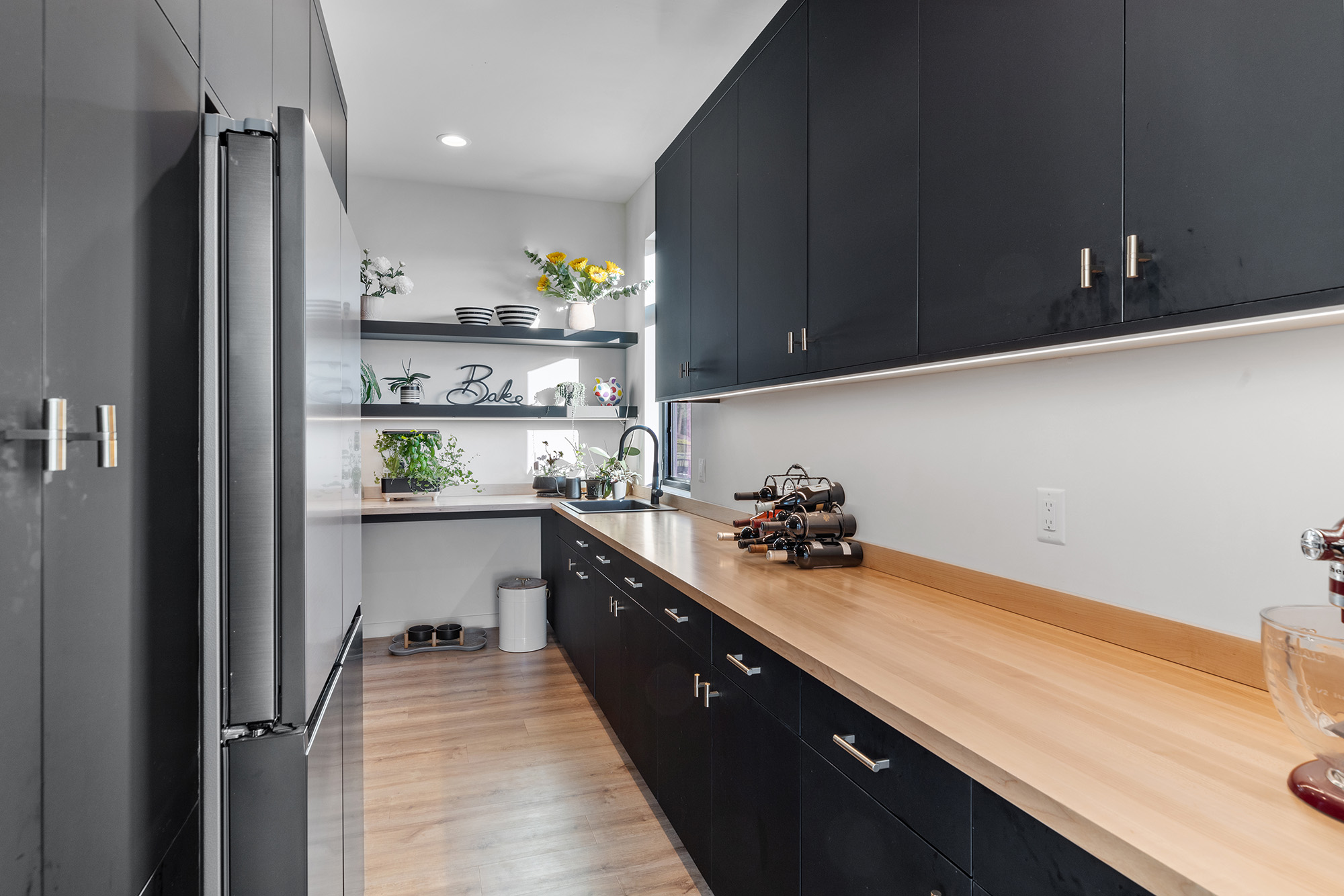 Walk-in pantry at Fernan Hill Residence in Coeur d’Alene, Idaho with custom shelving, modern cabinetry, and integrated storage