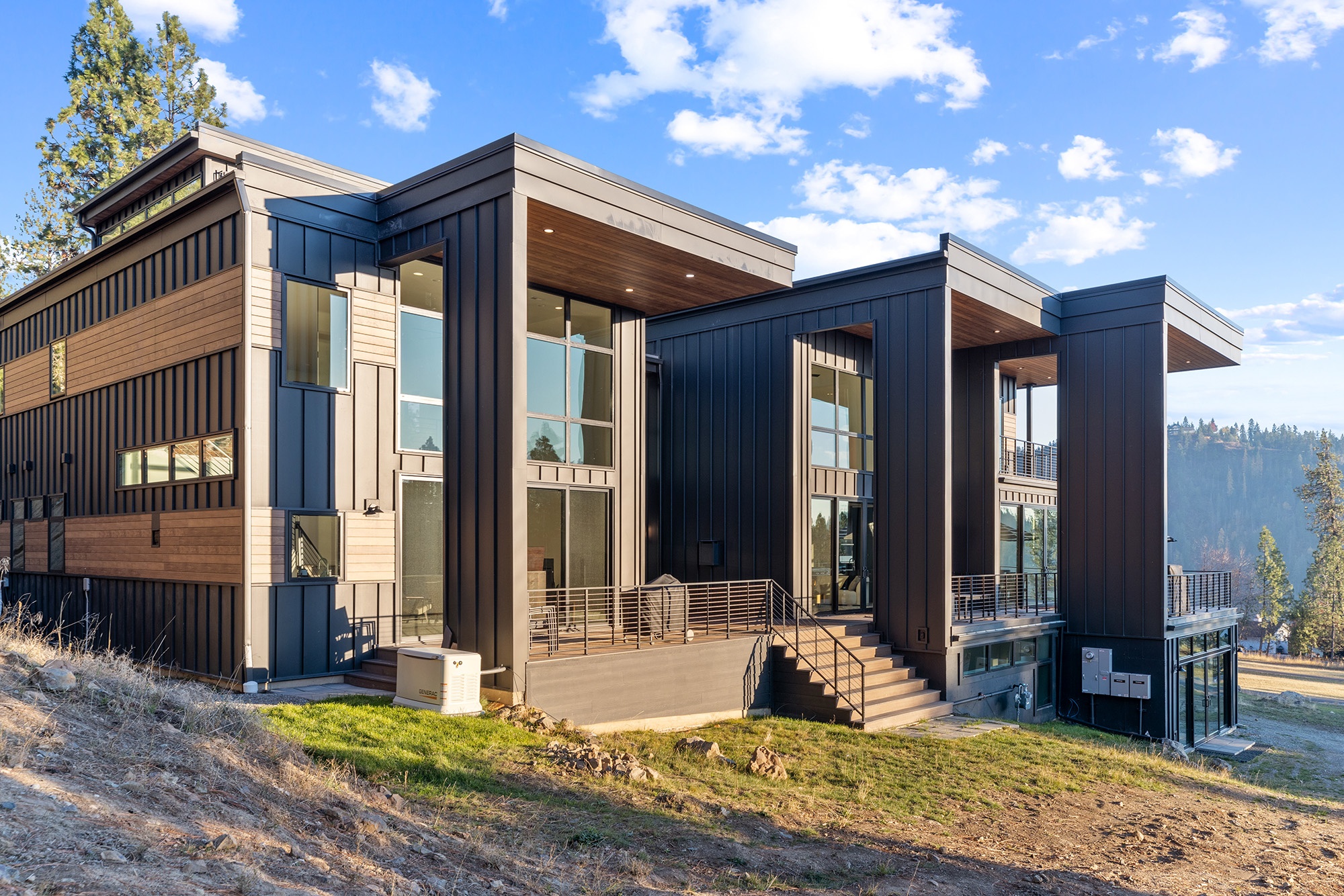 Covered portal patios at Fernan Hill Residence in CDA, Idaho with outdoor seating, wood detailing, and seamless indoor-outdoor living designed by Fusion Architecture